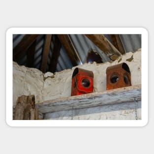 Two old red lanterns on white shelf. Sticker